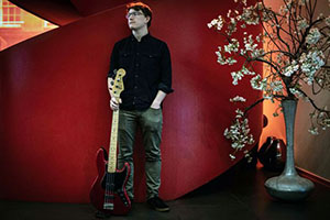 photo of David Bowden holding a bass guitar