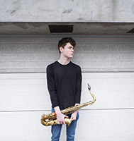photo of Matt Carmichael holding a saxophone